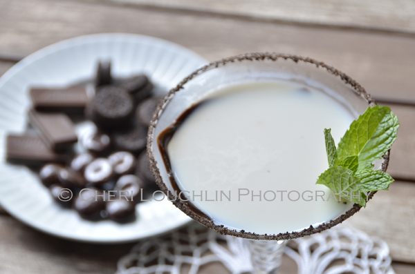 Chocolate Mint Cookie Cocktail 040 with Creme de Menthe Liqueur, Cake Vodka, Chocolate Vodka, Creme de Cacao, Half & Half with crushed Oreo cookie rim, chocolate swirl and mint leaf garnish. - recipe and photo by Mixologist Cheri Loughlin, The Intoxicologist