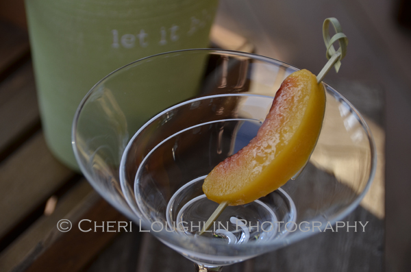 Frozen peach slice as garnish keeps the cocktail cold and you don't waste cutting into an entire peach for garnish. Score! – recipe and photo by Mixologist Cheri Loughlin, The Intoxicologist