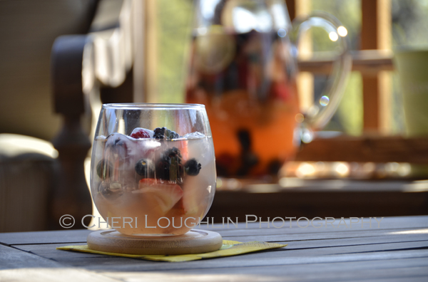 The berries soaked up quite a bit of the alcohol in the marinating process. To distribute the flavor I placed about 1/3 cup of berries in a goblet and very lightly mashed them with the back of a spoon. All the Beautiful Berries Sangria recipe and photo by Mixologist Cheri Loughlin, The Intoxicologist