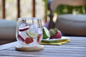 Garnish the Candy Girl cocktail by placing layer of ice, lime slices and strawberries. Repeat. - photo by Cheri Loughlin, The Intoxicologist