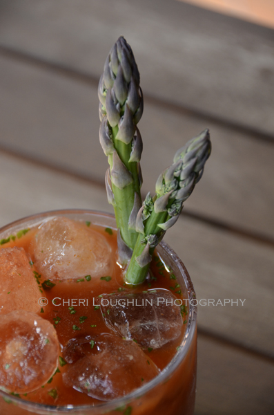 Twisted Sister Bloody Mary made with Campari, Bourbon and Gin. Garnished with asparagus spears. Includes seasonings of wasabi and ginger. An ideal masterpiece for the Bloody Mary Bar. - photo and recipe by Mixologist Cheri Loughlin, The Intoxicologist