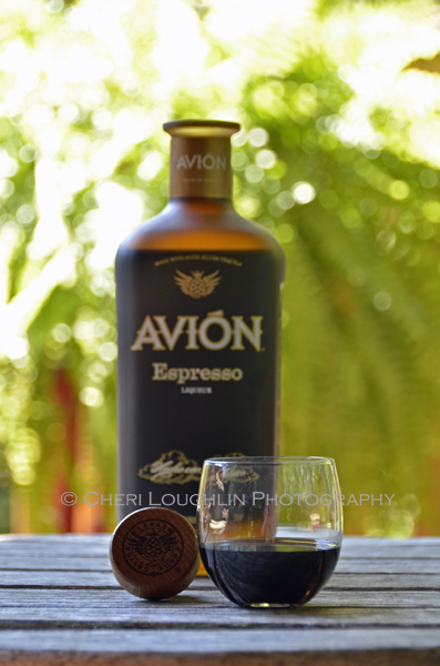 Avion Espresso Liqueur - Avion Tequila 020 Avion Espresso Liqueur taster shot with wooden bottle cap along side. - photo by Mixologist Cheri Loughlin, The Intoxicologist
