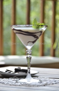 Chocolate Mint Cookie Cocktail 052 with Creme de Menthe Liqueur, Cake Vodka, Chocolate Vodka, Creme de Cacao, Half & Half with crushed Oreo cookie rim, chocolate swirl and mint leaf garnish. - recipe and photo by Mixologist Cheri Loughlin, The Intoxicologist