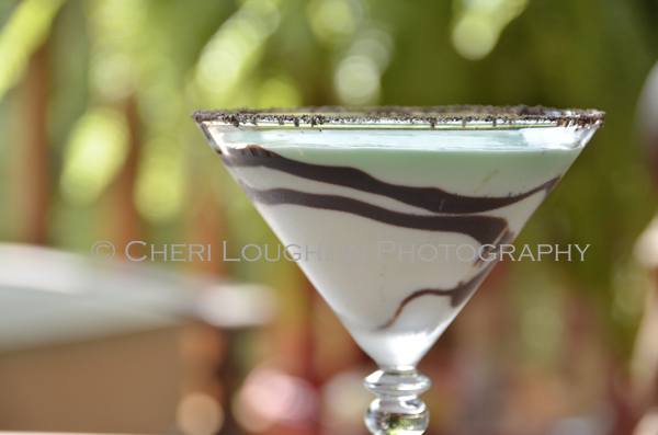 Chocolate Mint Cookie Cocktail 082 with Creme de Menthe Liqueur, Cake Vodka, Chocolate Vodka, Creme de Cacao, Half & Half with crushed Oreo cookie rim, chocolate swirl and mint leaf garnish. - recipe and photo by Mixologist Cheri Loughlin, The Intoxicologist