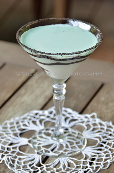 Chocolate Mint Cookie Cocktail 106 with Creme de Menthe Liqueur, Cake Vodka, Chocolate Vodka, Creme de Cacao, Half & Half with crushed Oreo cookie rim, chocolate swirl and mint leaf garnish. - recipe and photo by Mixologist Cheri Loughlin, The Intoxicologist