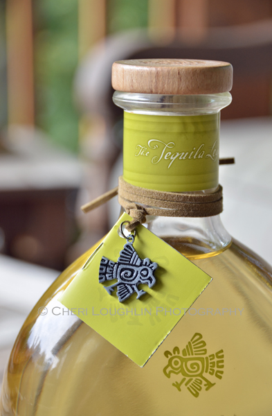Partida Tequila Reposado 002 close up of bottle neck and bird logo. - photo by Mixologist Cheri Loughlin, The Intoxicologist