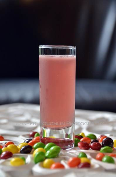 Skittle Shot is a fun candy themed shot ideal for Halloween parties, celebrating PINK for Breast Cancer Awareness month and of course raising a toast to National Vodka Day. - photo credit to Mixologist Cheri Loughlin, The Intoxicologist