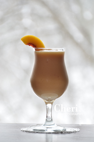 Peachy Pina Colada – recipe by Cheri Loughlin, The Intoxicologist 2 ounces Spiced Rum 1-3/4 ounces Pineapple Juice 1-1/4 ounce Orange Juice 2 ounces Cream of Coconut 1 ounce Unsweetened Almond Milk 8 Frozen Peach Slices 1 cup Crushed Ice Peach Slice Garnish