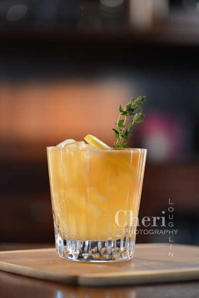 The Dark Ginger Thyme Storm variation of the Dark & Stormy with fresh lemon and dark ginger thyme syrup.